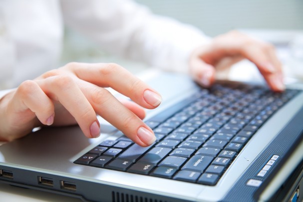 Human hands working on laptop on office background